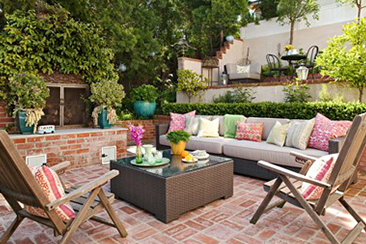 Outdoor patio seating with pillows in the sunshine